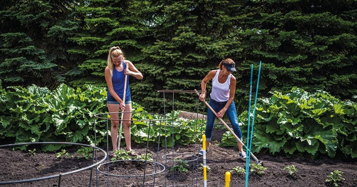 Tracie Thompson works in the garden with her 14-year-old daughter, Jamie, who has taken over much of the dirt work so her mom can run the local grocery store in Westhope. “I couldn’t do it without my daughter,” Tracie says.