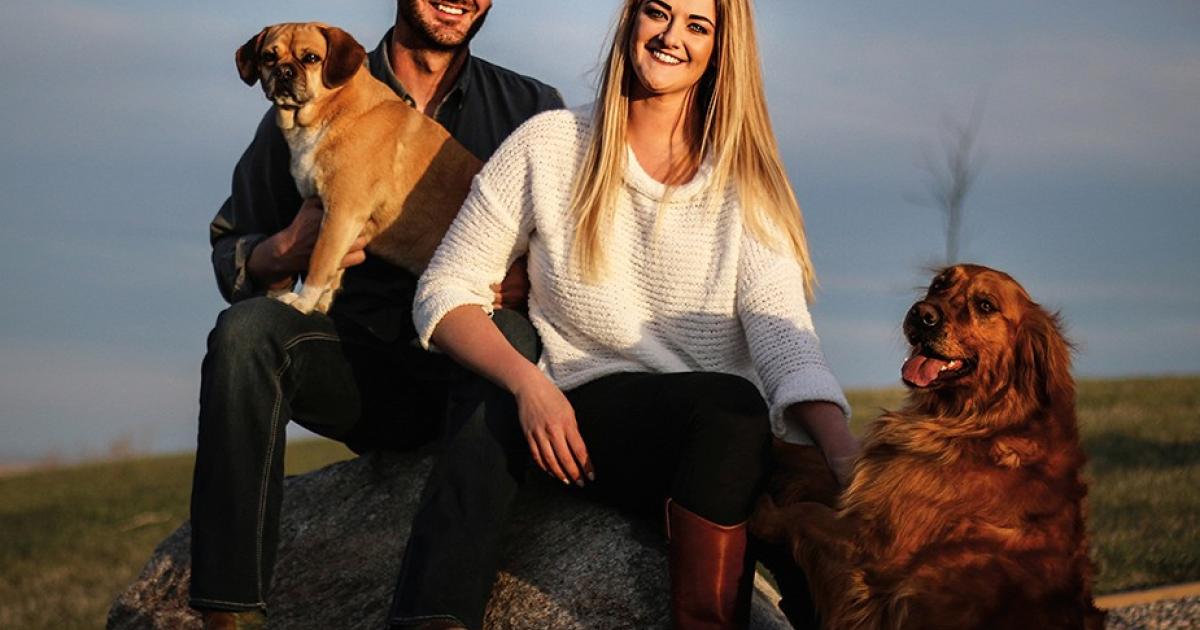 Editor Cally Peterson and her husband, Darin, are pictured with their dogs, Raina and Aspen, at their home in rural Steele. Courtesy photo