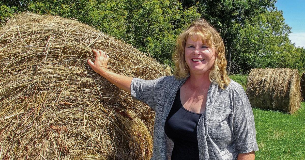 This summer, Susie Nitschke and her brother-in-law, Brian Nitschke, are putting up hay to feed cattle through winter.  Photo by Pat Schaffer/Dakota Valley Electric Cooperative