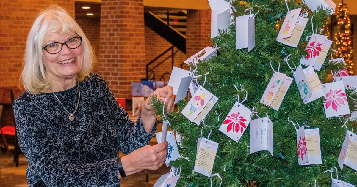 Mary Ann Ouradnik decorates Olivet Lutheran’s Giving Tree of Hope with handmade ornaments, a volunteer task she’s done for over 30 years.