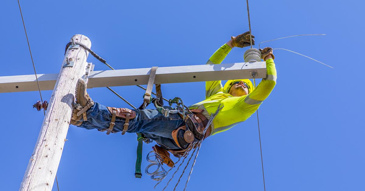 Brad Schmitt, an apprentice line technician with Slope Electric Cooperative, repairs a damaged power line near Crosby May 4.