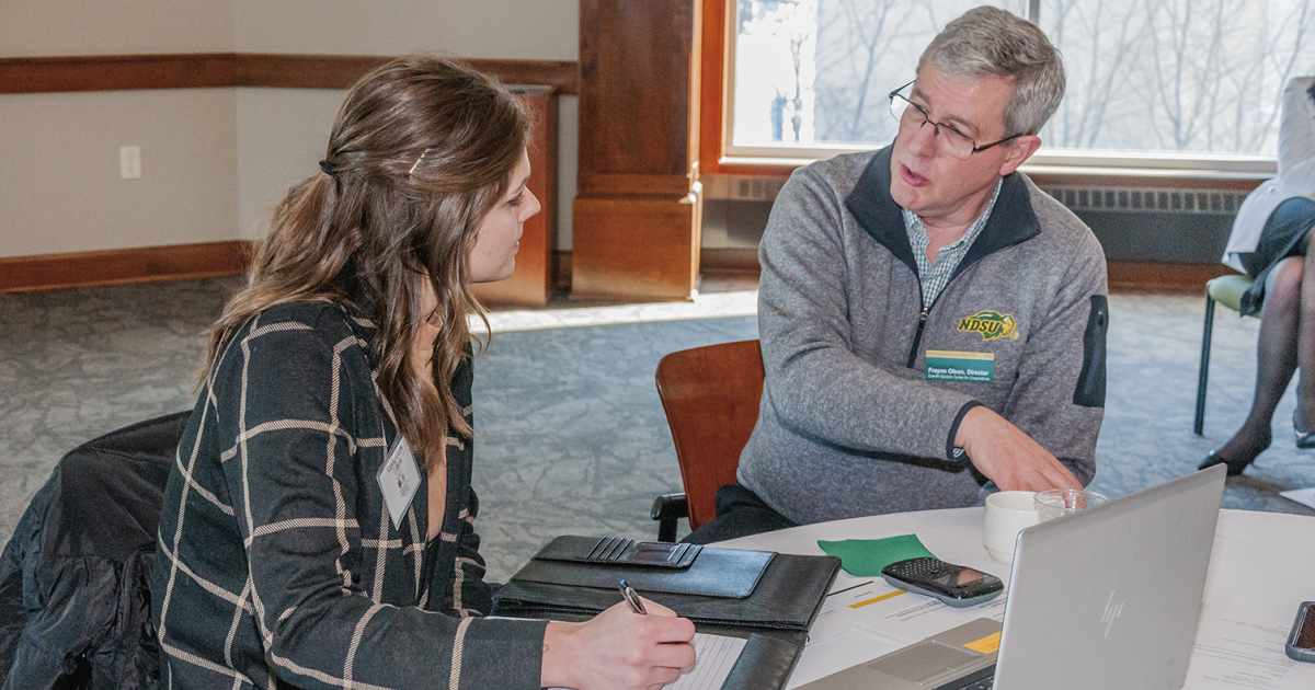 Frayne Olson, executive director of the Quentin Burdick Center for Cooperatives, visits with Katelyn Long, a graduate student whose research project focuses on co-op equity management and co-op finance.