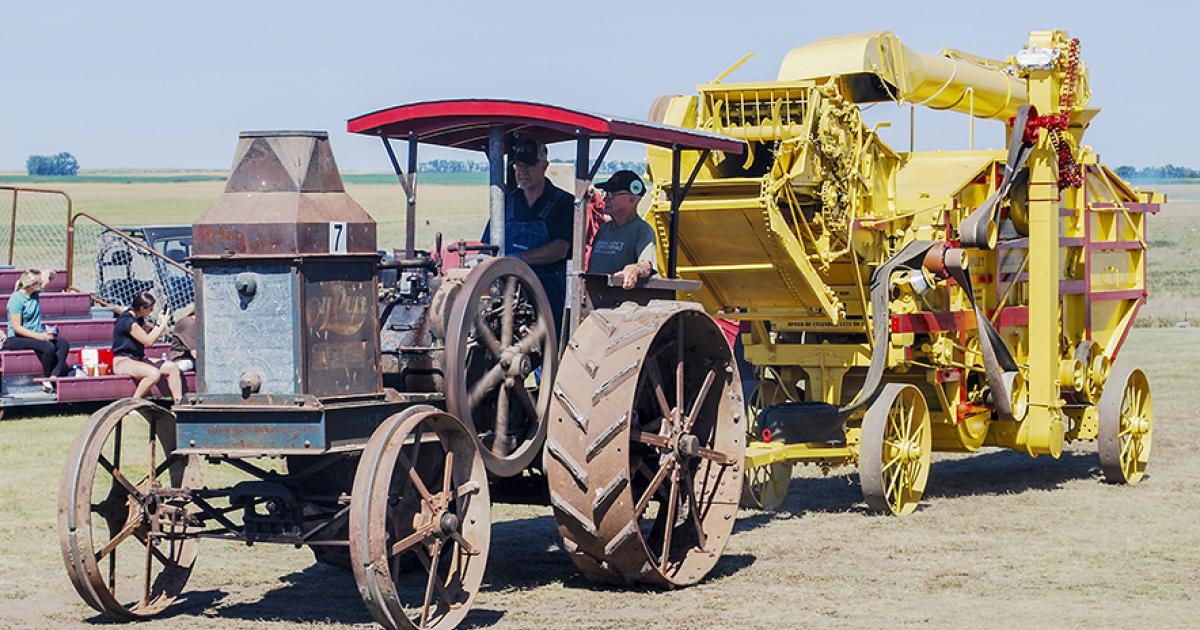 Del Svalen rides on the back of his family’s 1919 Rumely tractor