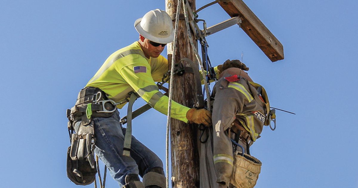 McKenzie Electric Cooperative lineworker Eric Hellandsaas performs a simulated pole-top rescue.