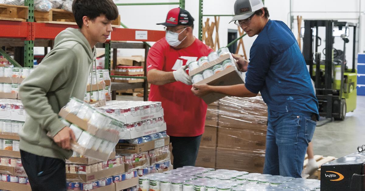 Employees unload food items for the Spirit Lake Food Distribution Program.