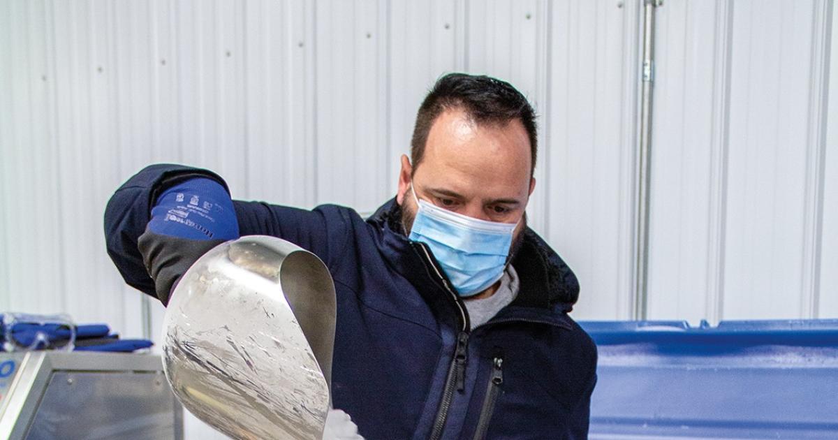 A N.D. Department of Health employee pours dry ice into a shipper, which is used to transport COVID-19 vaccines. Photo courtesy N.D. Department of Health